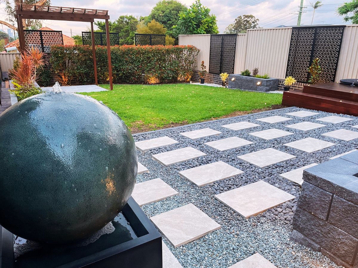 Finished backyard landscaping project with garden boxes and water fountain in Ermington