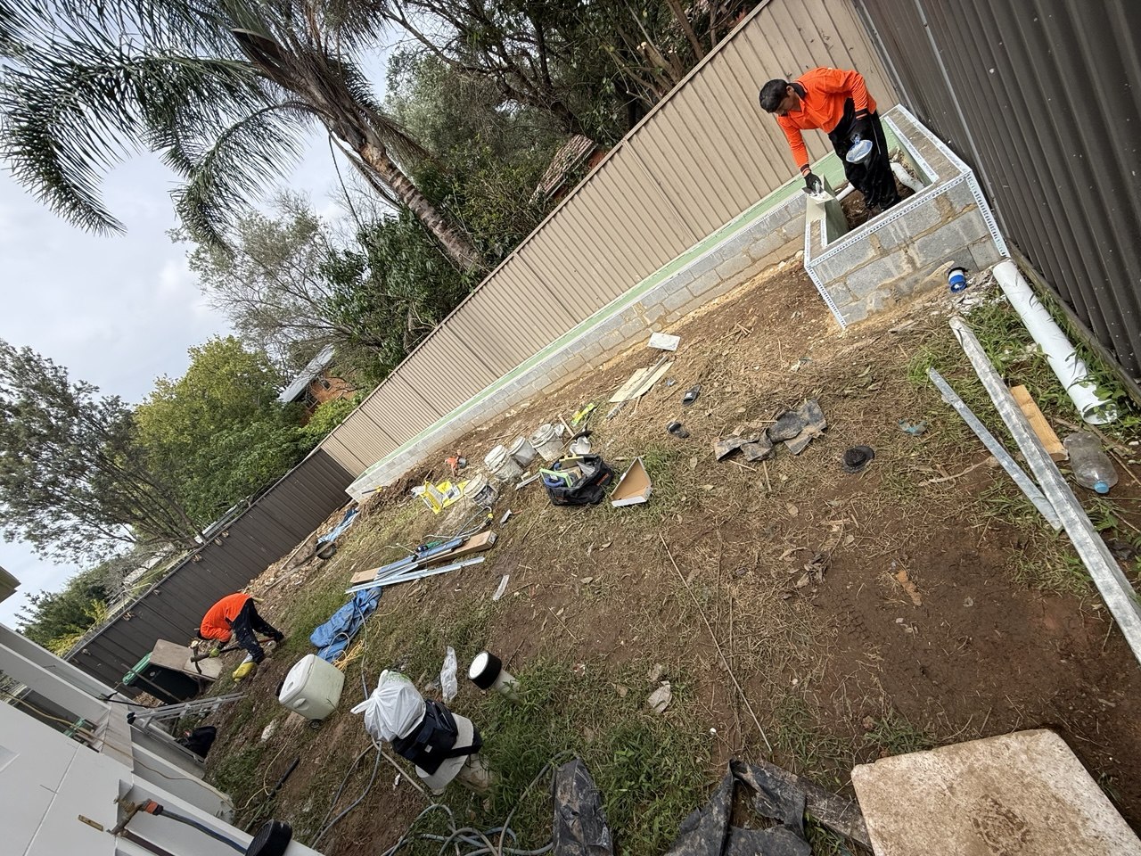 Concrete block garden box under construction along the boundary fence, Eastwood Sydney