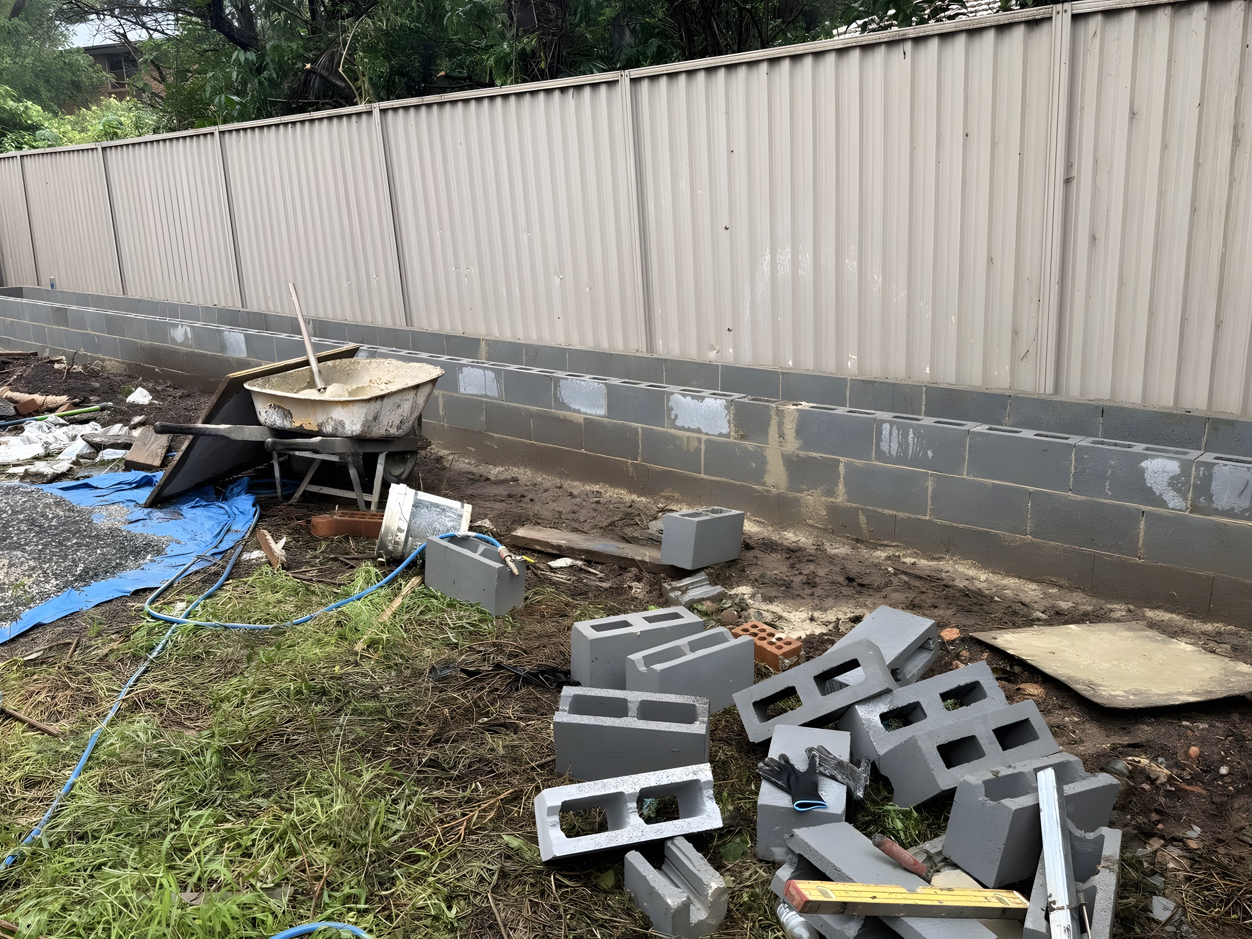 Block garden wall built along the fence line in Hunters Hill