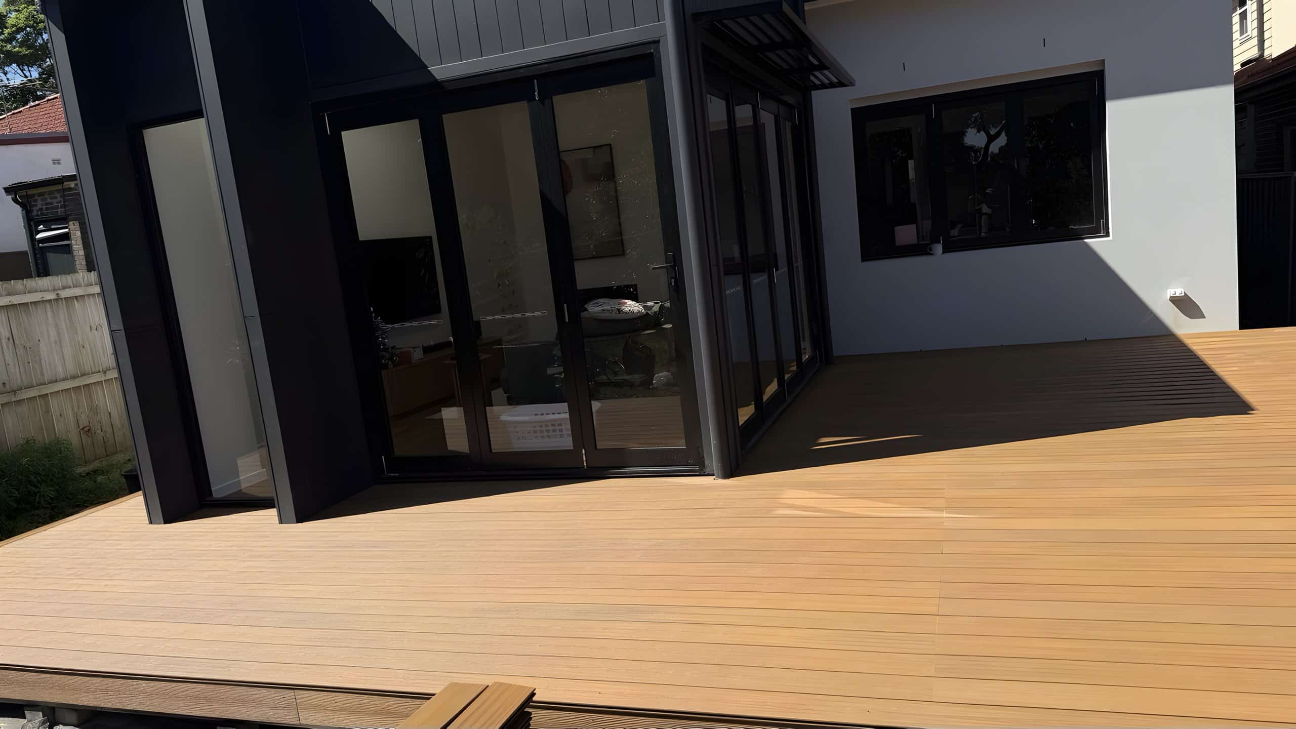 Finished composite deck off black bi-fold doors at a Five Dock home