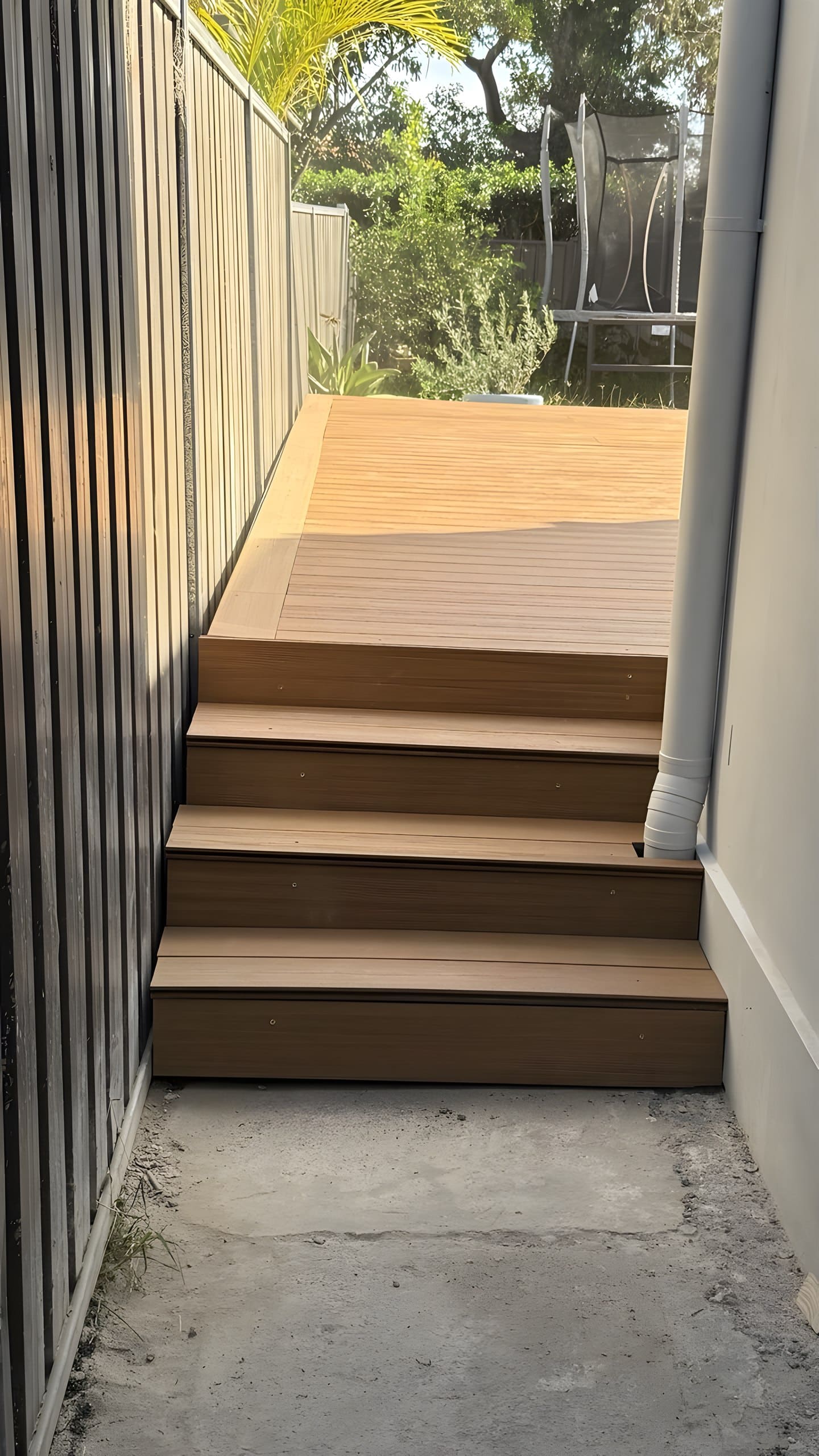New composite stairs beside house connecting deck and side passage Five Dock