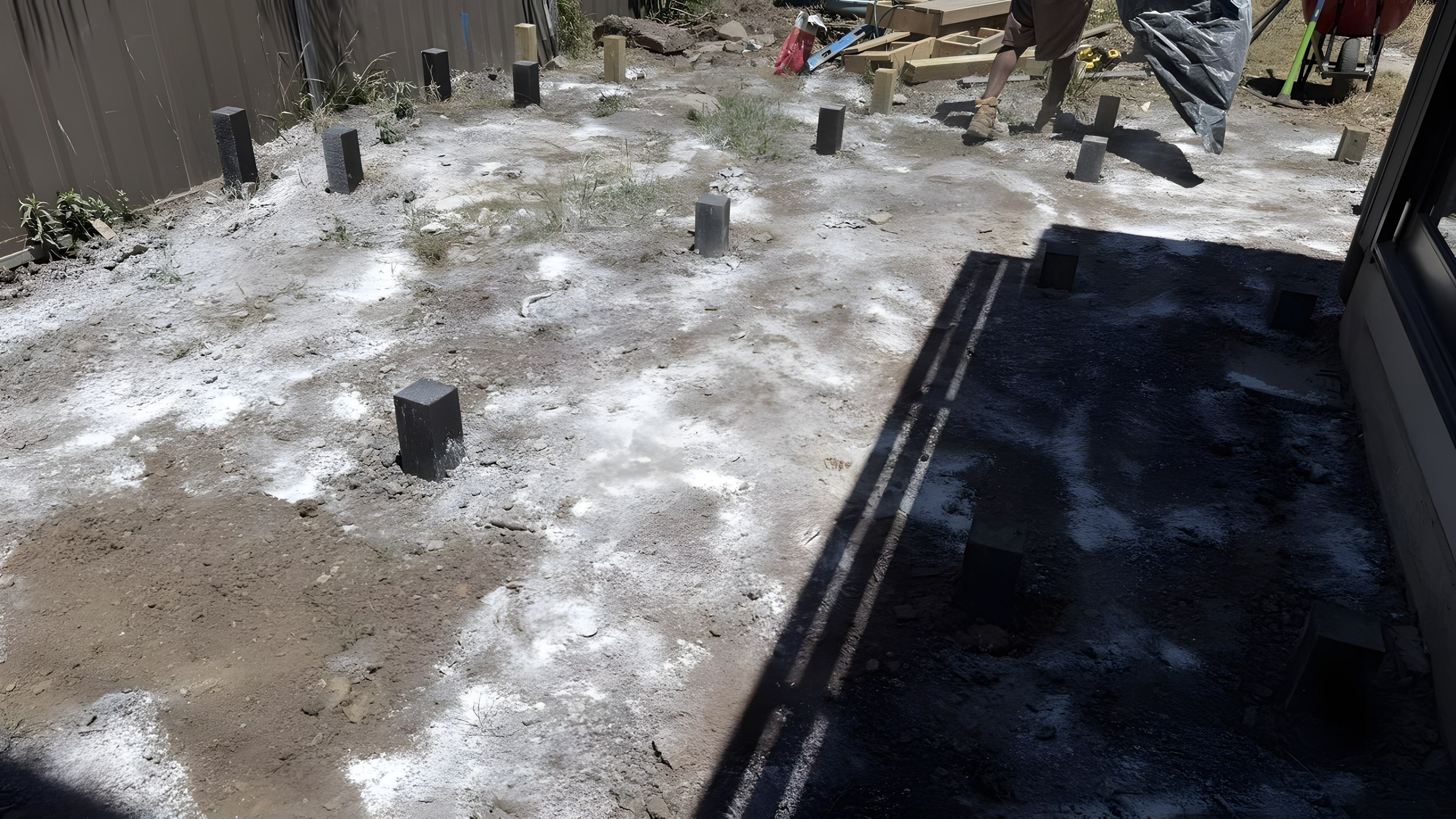 Five Dock backyard before decking with footings set out in bare soil