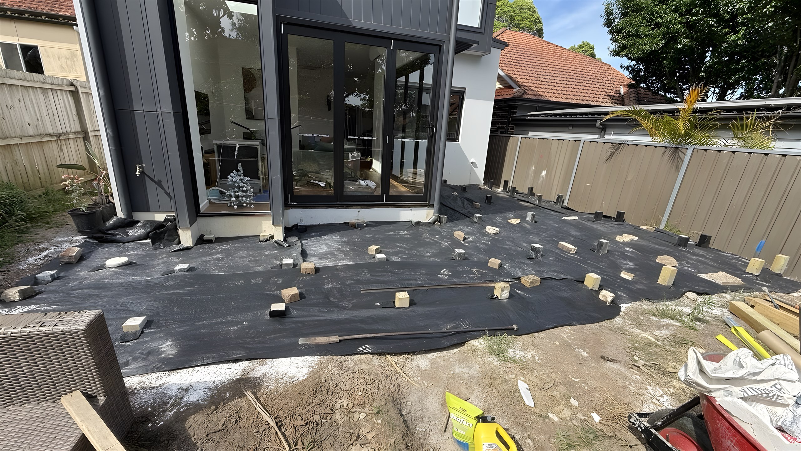 Deck area prepared with weed mat and footings behind a Five Dock extension