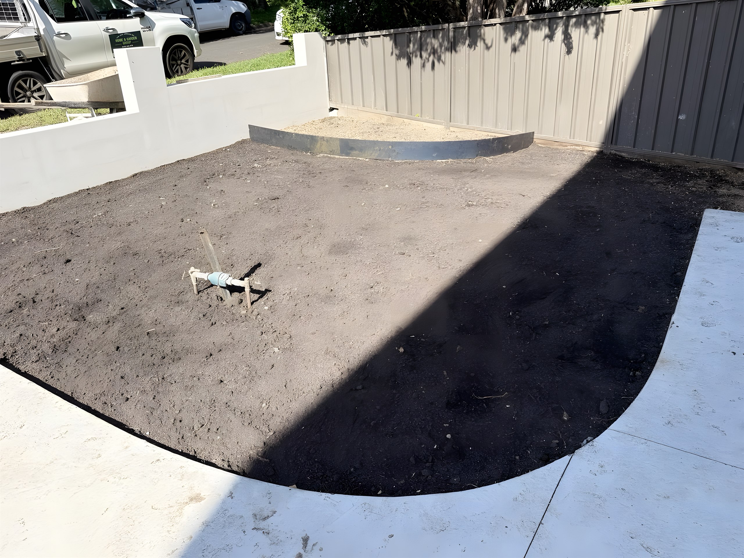 Levelled soil and curved steel garden edging ready for turf in Hunters Hill