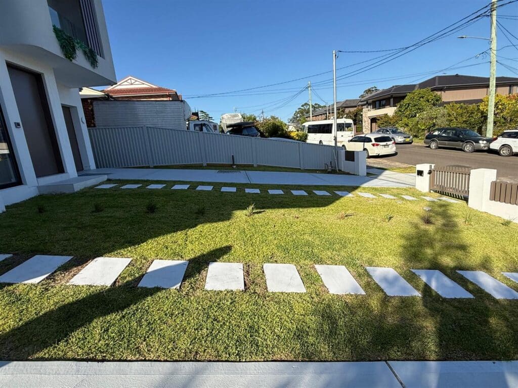 New turf and stepping pavers at a modern home
